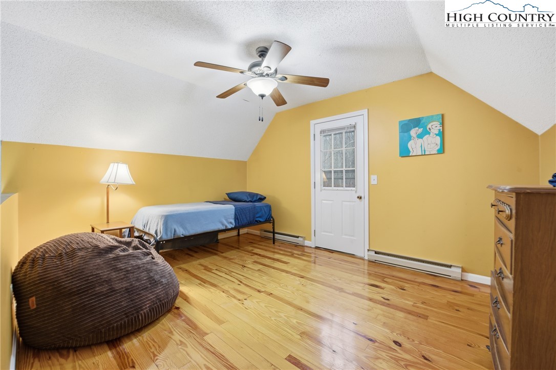 476 Moon Ridge Road Crumpler, NC 28617 - Photo 20 of 35 a view of a bedroom with a bed and wooden floor