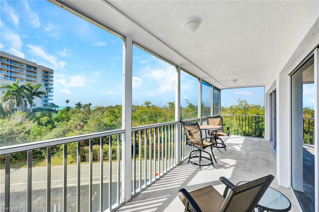 1 Bluebill Avenue, Unit 409 Naples, FL 34108 - Photo 14 of 25 a view of a chairs and table in patio with potted plants