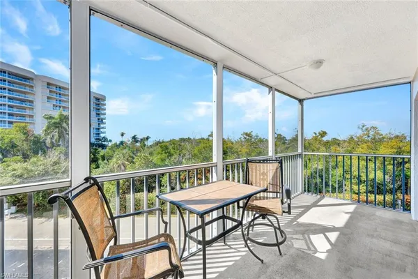 a view of a chairs and table in patio with potted plants