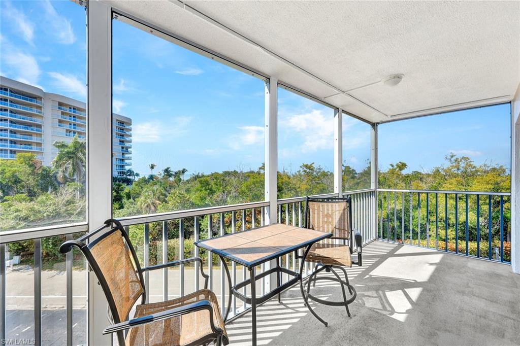 1 Bluebill Avenue, Unit 409 Naples, FL 34108 - Photo 15 of 25 a view of a chairs and table in the balcony