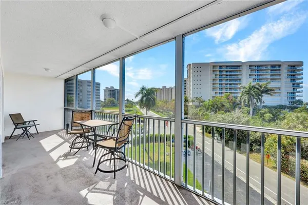 a view of a chairs and table in the balcony