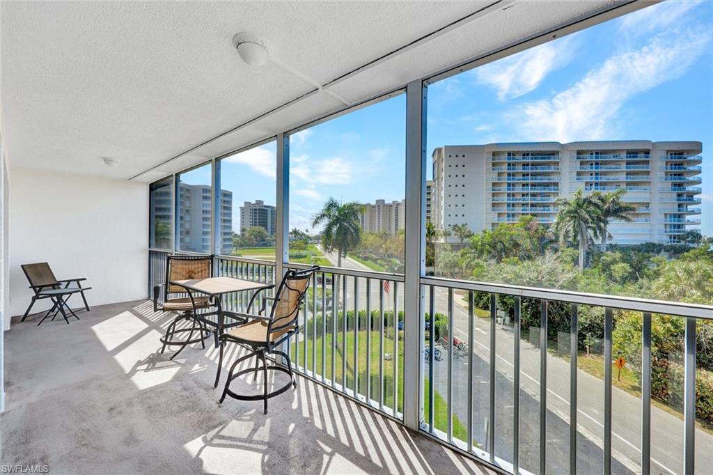 1 Bluebill Avenue, Unit 409 Naples, FL 34108 - Photo 16 of 25 a view of a chairs and table in patio