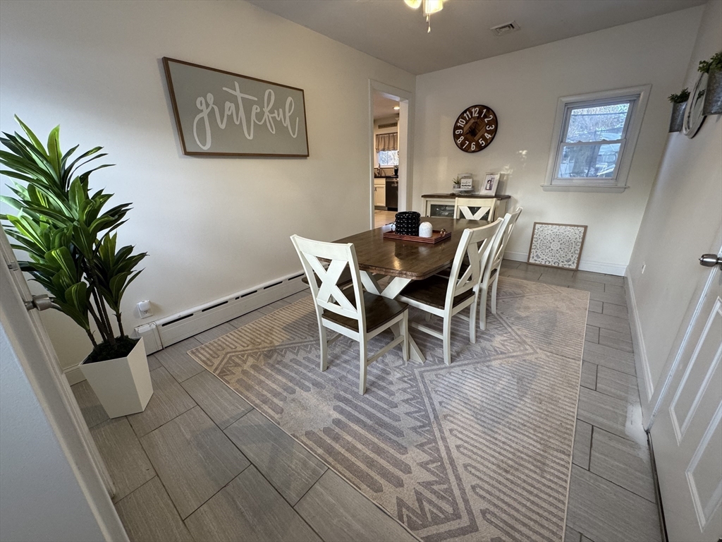 9 Rochambeau Street Fairhaven, MA 02719 - Photo 8 of 18 a view of a dining room with furniture and a potted plant