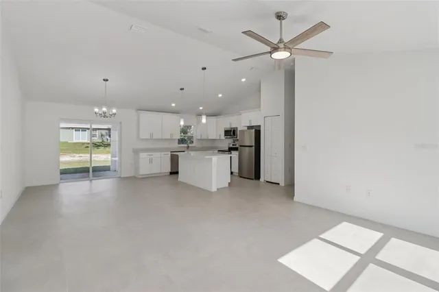 a view of a kitchen with a sink and a refrigerator