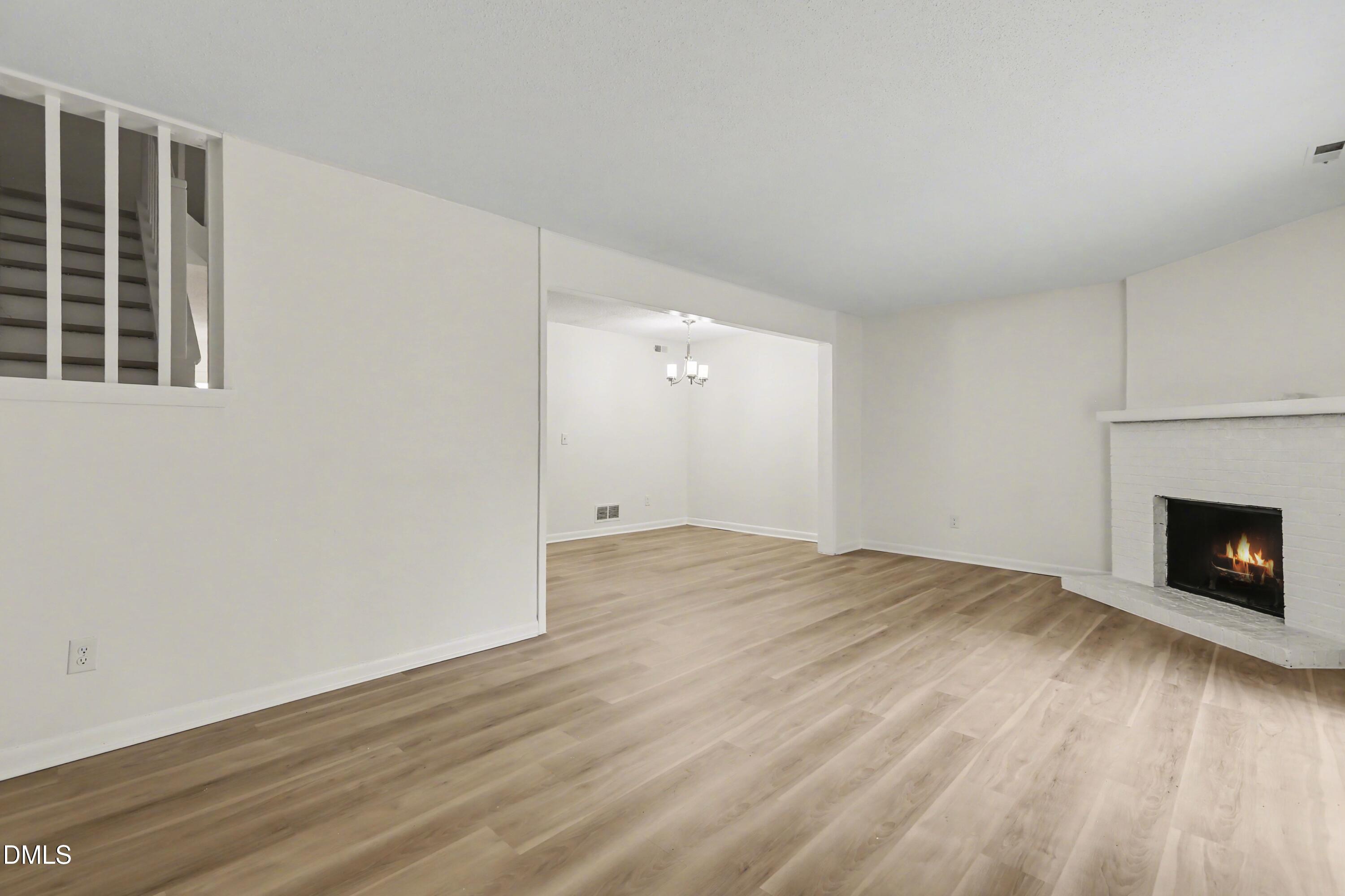 1304 Seaton Road, Unit 30 Durham, NC 27713 - Photo 11 of 25 a view of empty room with wooden floor and fireplace