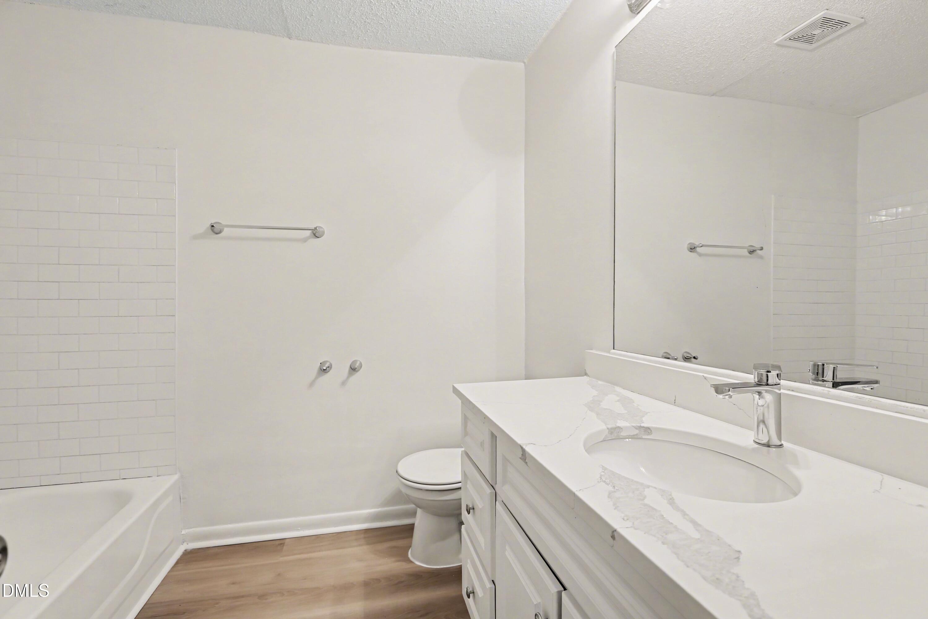 1304 Seaton Road, Unit 30 Durham, NC 27713 - Photo 18 of 25 a bathroom with a sink toilet vanity and bathtub