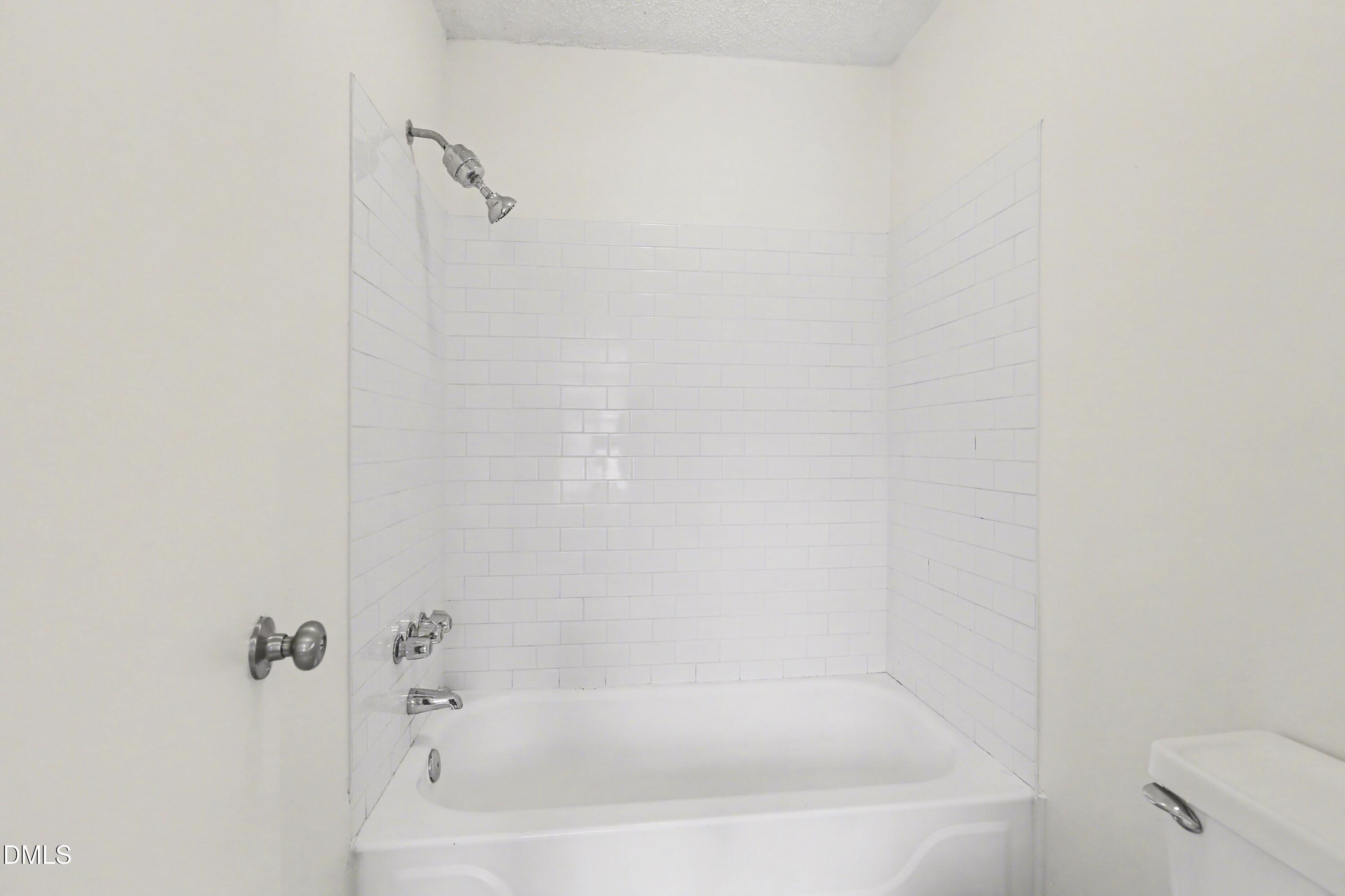 1304 Seaton Road, Unit 30 Durham, NC 27713 - Photo 22 of 25 a close up of a bathtub in a bathroom