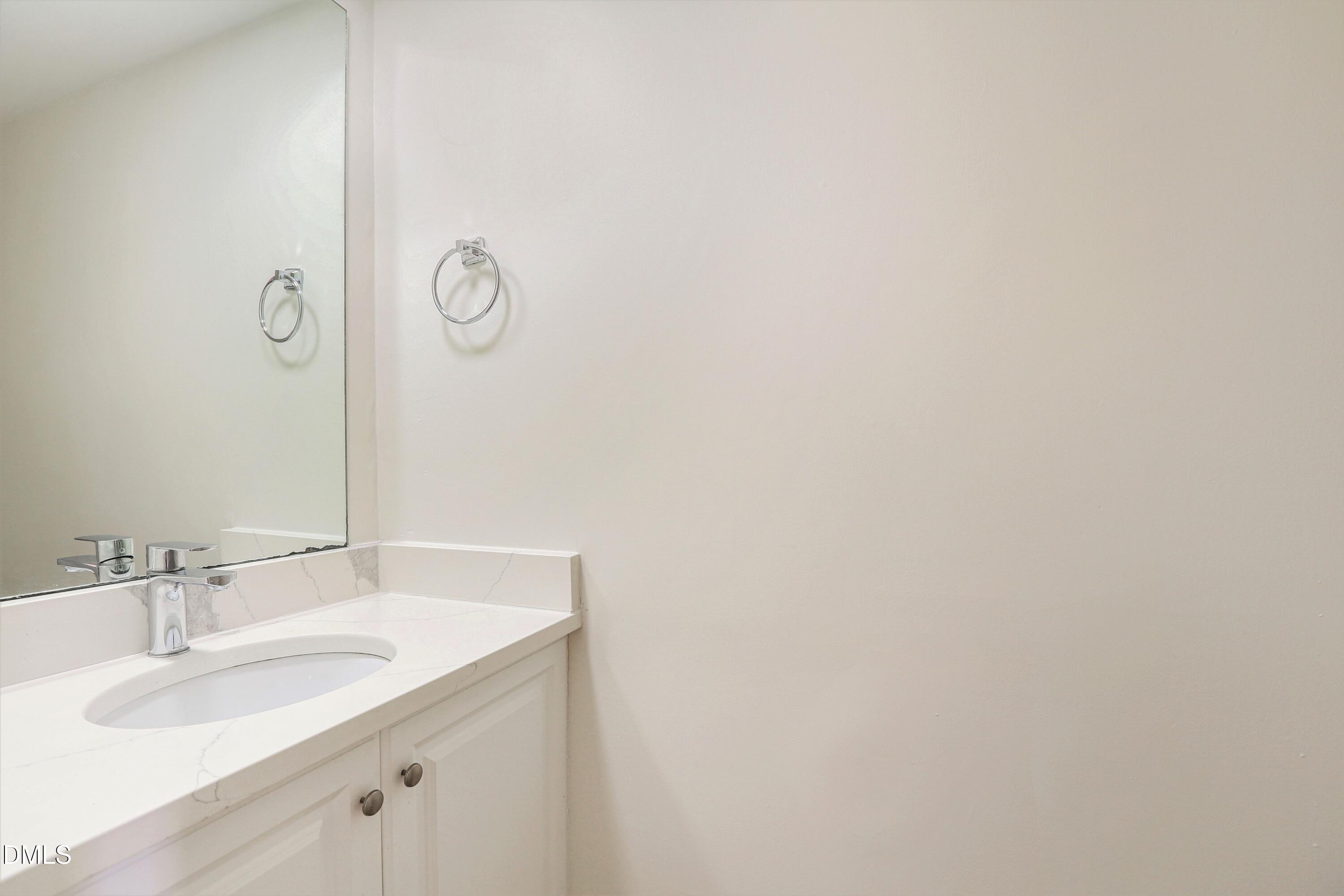1304 Seaton Road, Unit 30 Durham, NC 27713 - Photo 23 of 25 a bathroom with a sink and a mirror