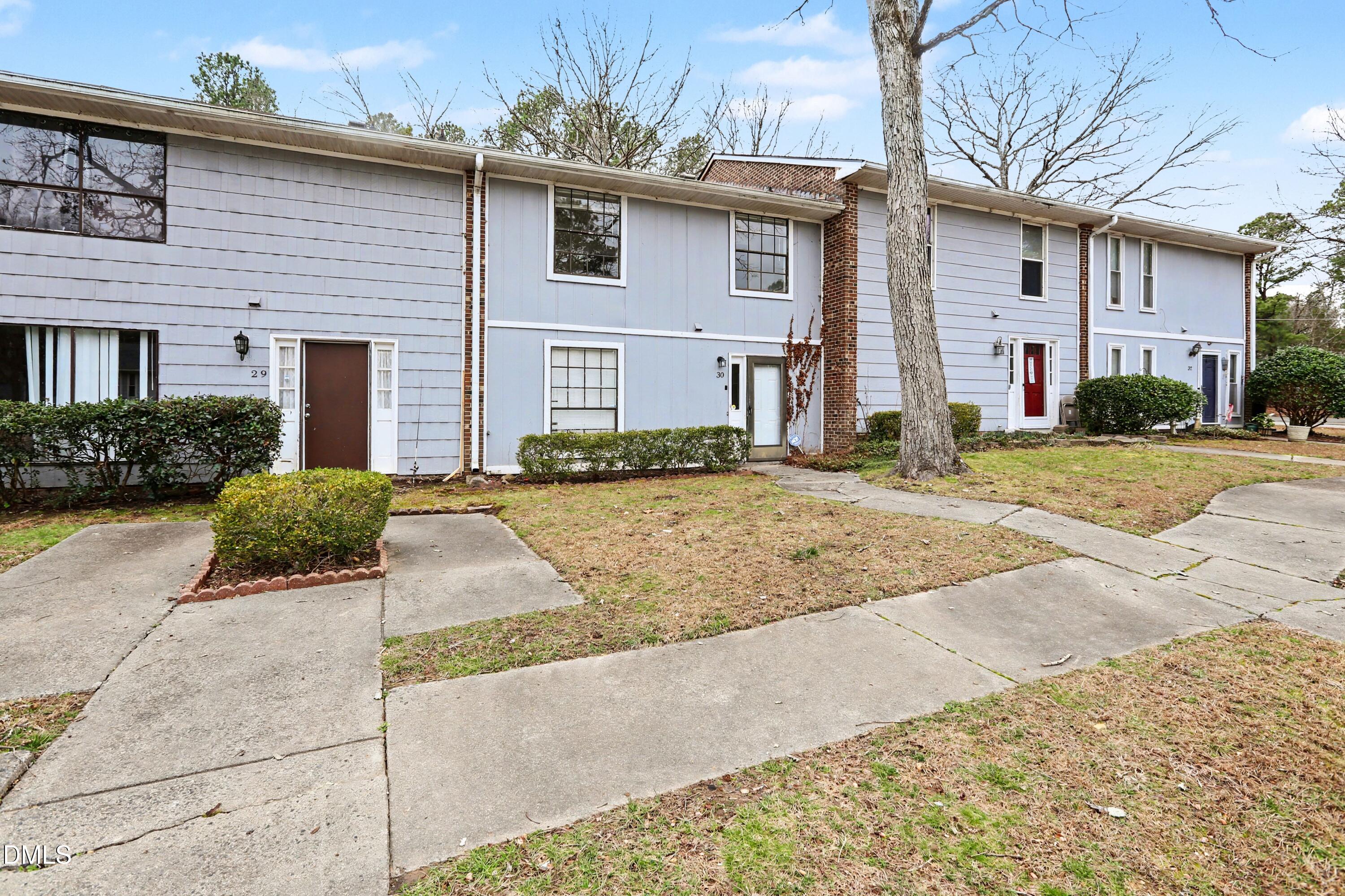 1304 Seaton Road, Unit 30 Durham, NC 27713 - Photo 3 of 25 a front view of a house with a yard and garage