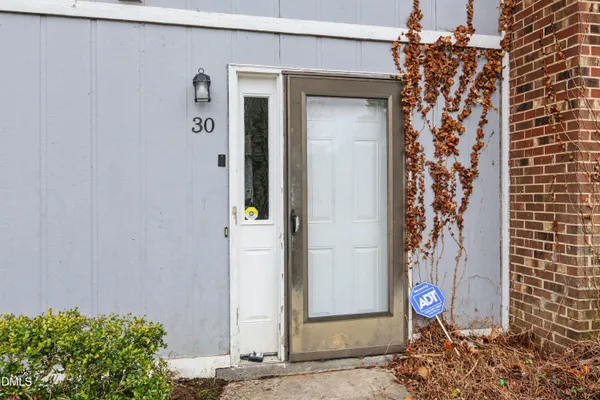 a view of a hallway with wooden floor and entryway