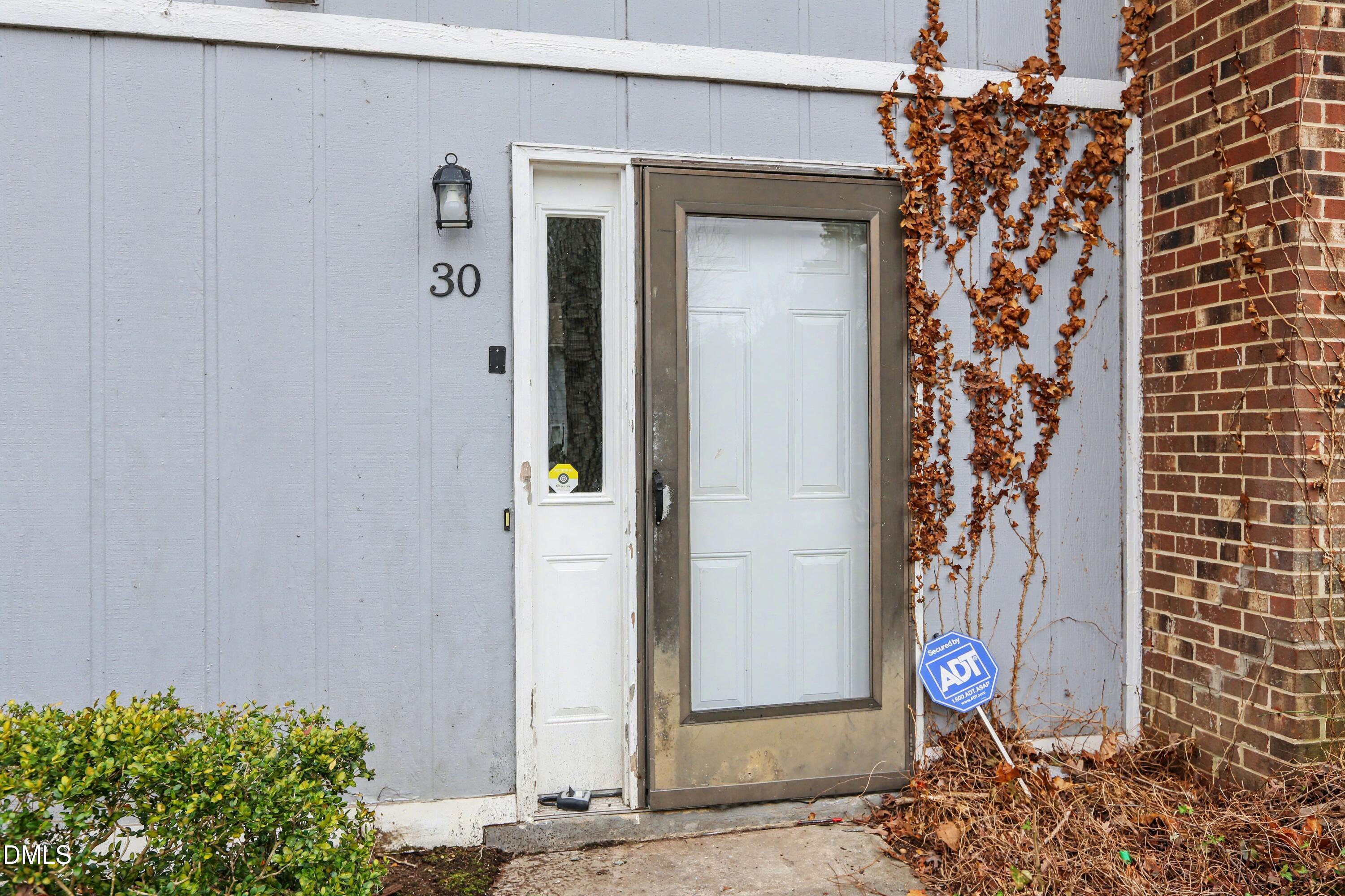 1304 Seaton Road, Unit 30 Durham, NC 27713 - Photo 4 of 25 a view of a house with a potted plant sign