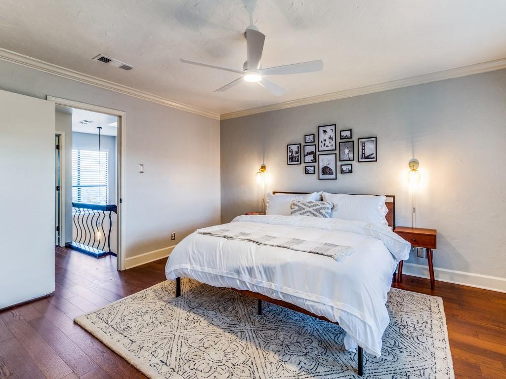 531 Josephine Street Dallas, TX 75246 - Photo 15 of 25 a bedroom with a bed and wooden floor