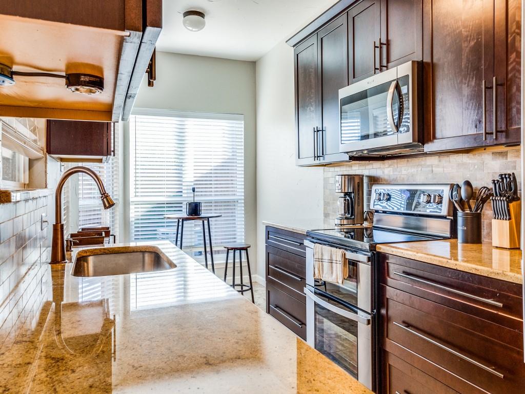 531 Josephine Street Dallas, TX 75246 - Photo 9 of 25 a kitchen with stainless steel appliances granite countertop a sink and a microwave