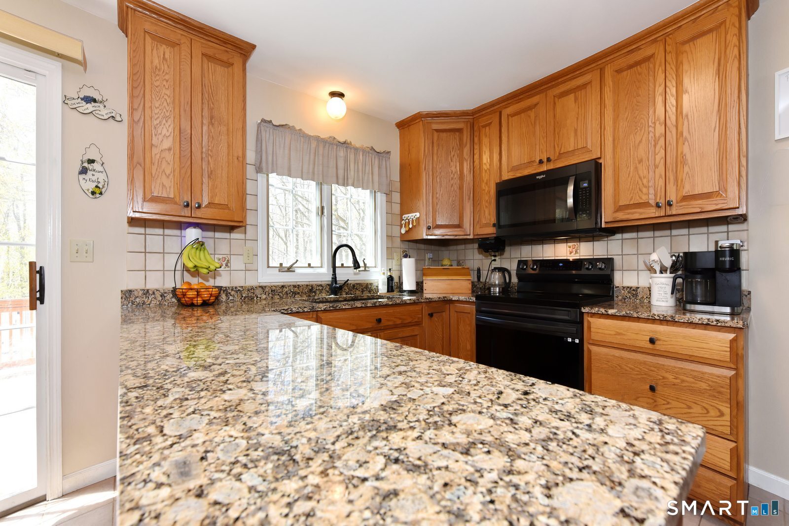 31 North Maple Street East Hampton, CT 06424 - Photo 12 of 38 a kitchen with a stove a sink and a microwave