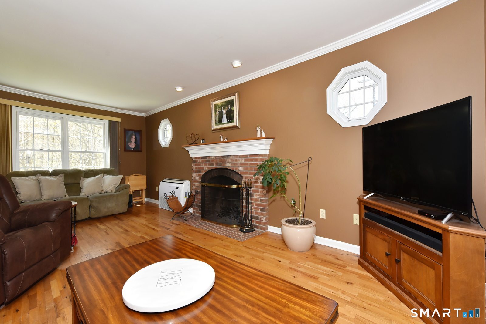31 North Maple Street East Hampton, CT 06424 - Photo 18 of 38 a living room with furniture a fireplace and a flat screen tv