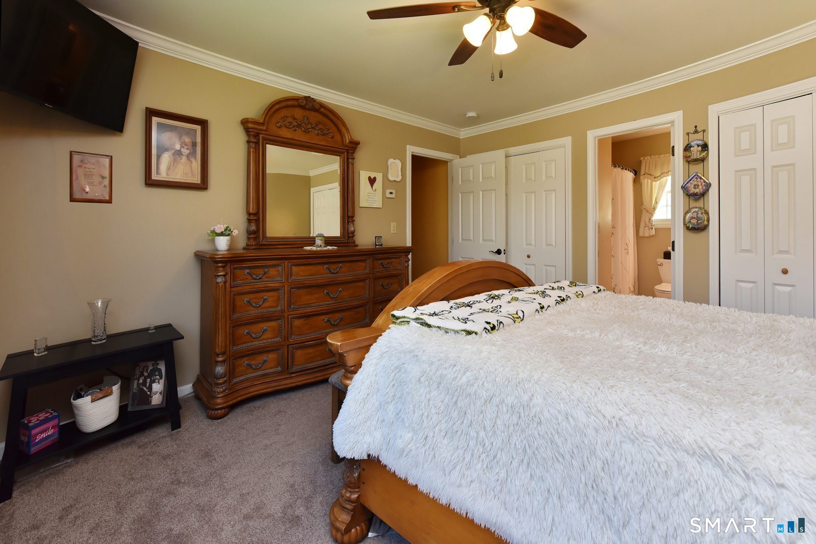 31 North Maple Street East Hampton, CT 06424 - Photo 28 of 38 a spacious bedroom with a bed and a chandelier
