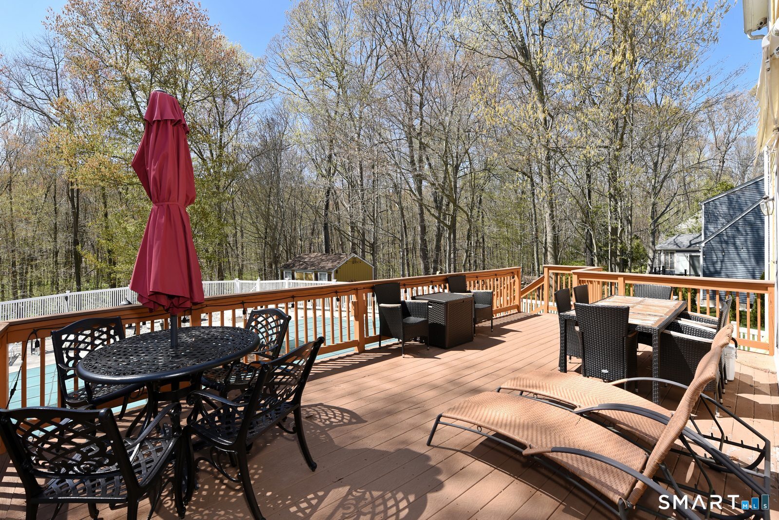 31 North Maple Street East Hampton, CT 06424 - Photo 32 of 38 a view of a patio with table and chairs with wooden floor and fence