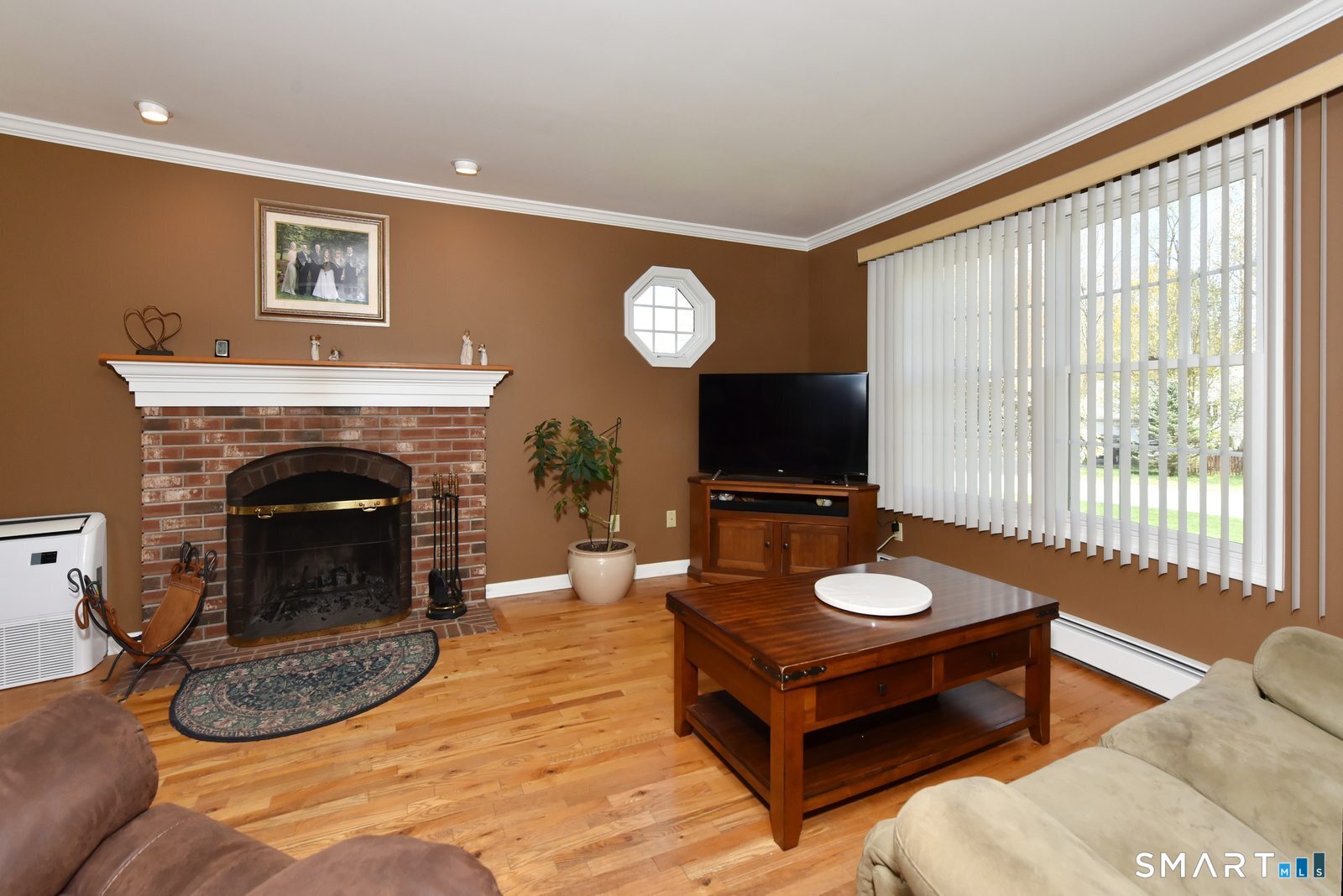 31 North Maple Street East Hampton, CT 06424 - Photo 4 of 38 a living room with furniture a window and a fireplace