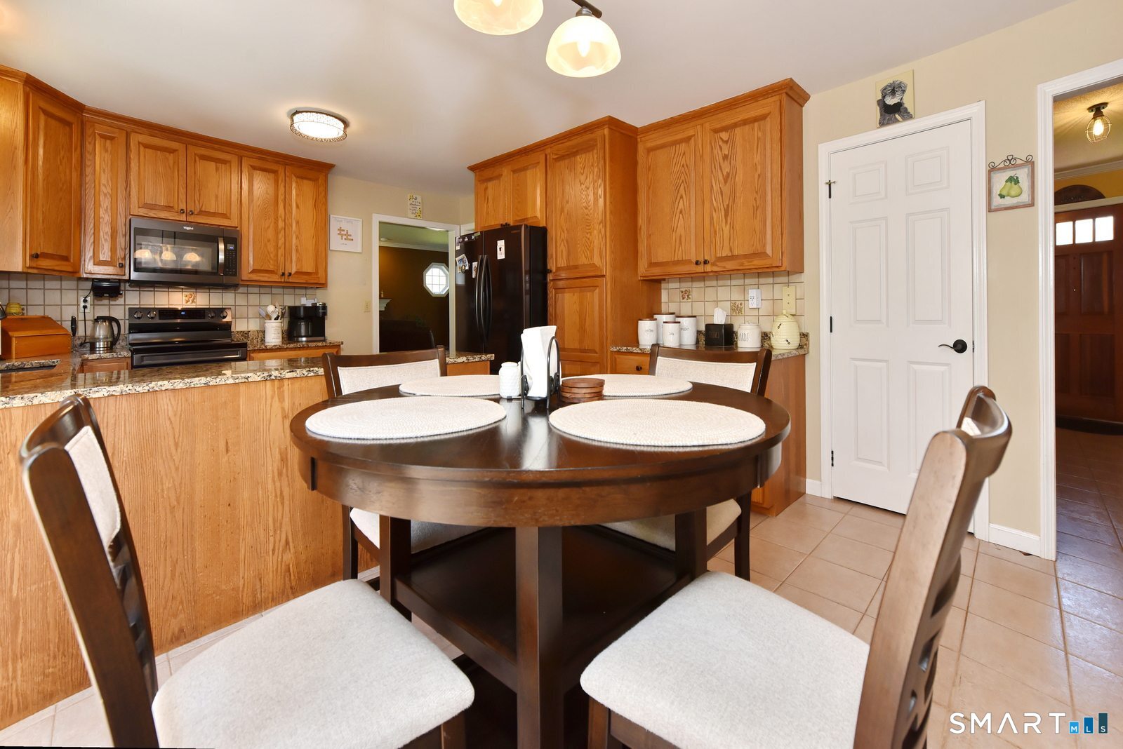 31 North Maple Street East Hampton, CT 06424 - Photo 7 of 38 a kitchen with a table chairs sink and microwave