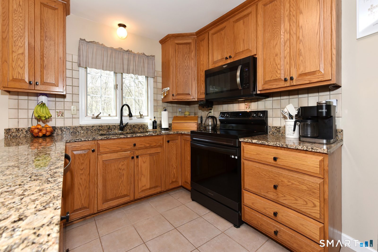 31 North Maple Street East Hampton, CT 06424 - Photo 8 of 38 a kitchen with stainless steel appliances granite countertop a stove a sink and a microwave