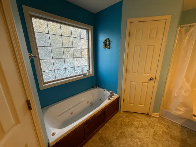 a bathroom with a tub and shower