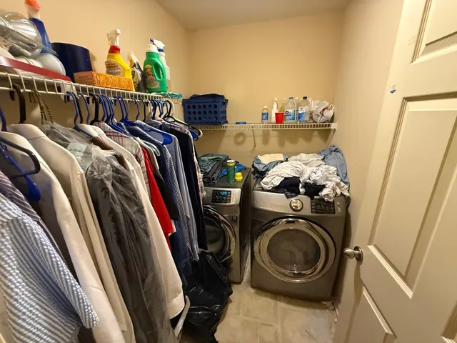 a view of walk in closet with clothes and shoes
