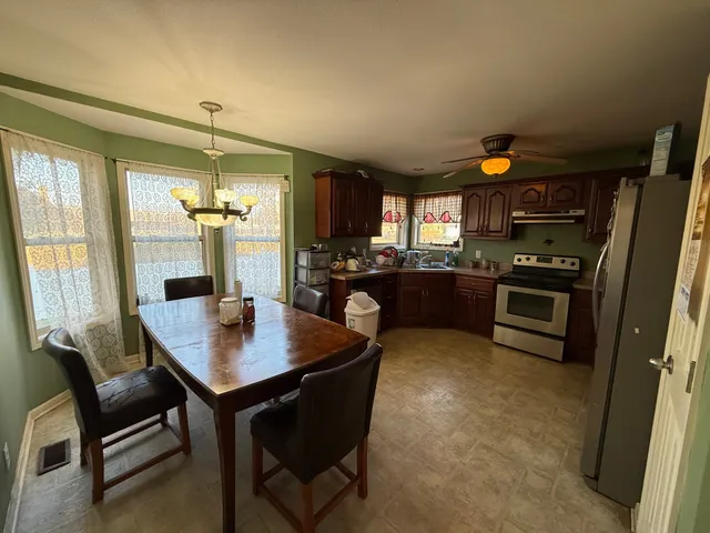 a kitchen with a table chairs and stove