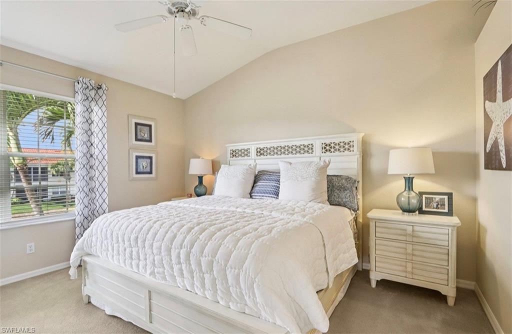 10911 Oak Island Road, Unit 201 Estero, FL 34135 - Photo 12 of 24 a bedroom with a large bed and a chandelier