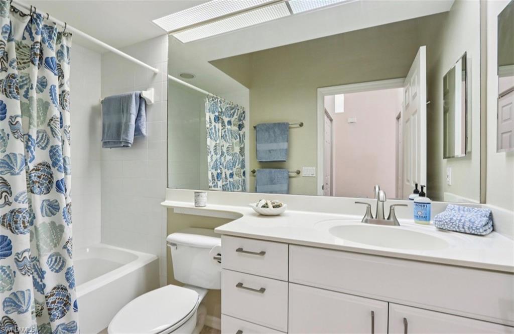 10911 Oak Island Road, Unit 201 Estero, FL 34135 - Photo 17 of 24 a bathroom with a double vanity sink toilet and shower