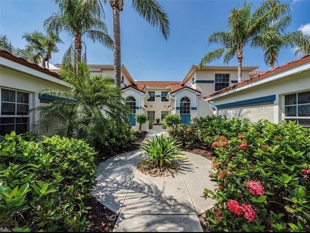 10911 Oak Island Road, Unit 201 Estero, FL 34135 - Photo 22 of 24 a front view of a house with a garden