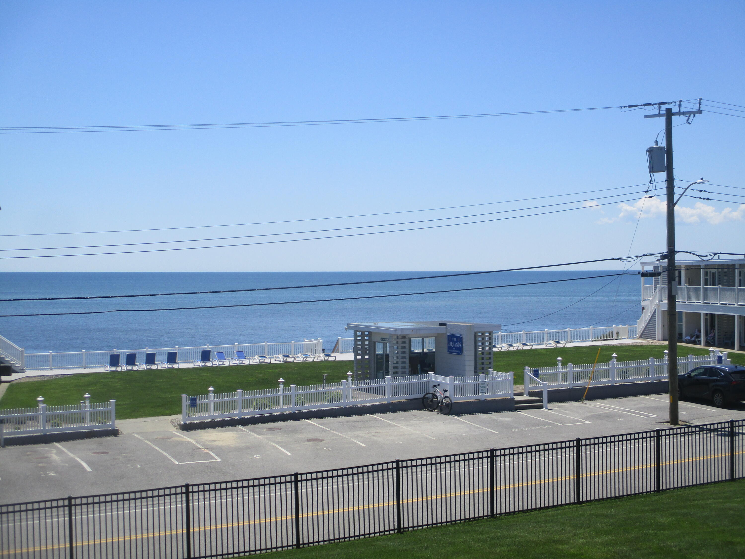 112 Old Wharf Road, Unit E4 Dennis Port, MA 02639 - Photo 2 of 15 a view of a balcony with floor to ceiling windows with wooden fence