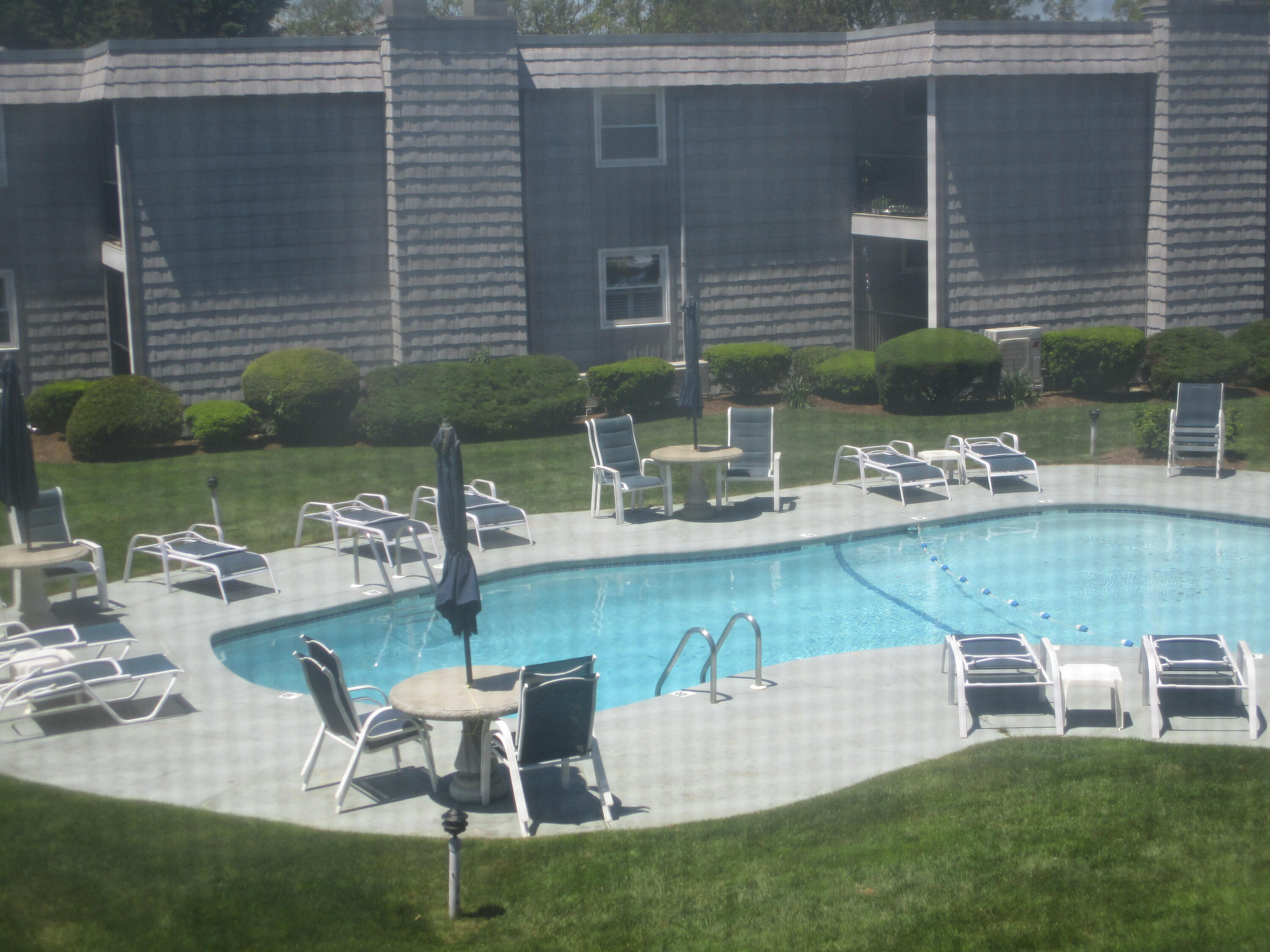 112 Old Wharf Road, Unit E4 Dennis Port, MA 02639 - Photo 3 of 15 a view of a patio with table and chairs and potted plants