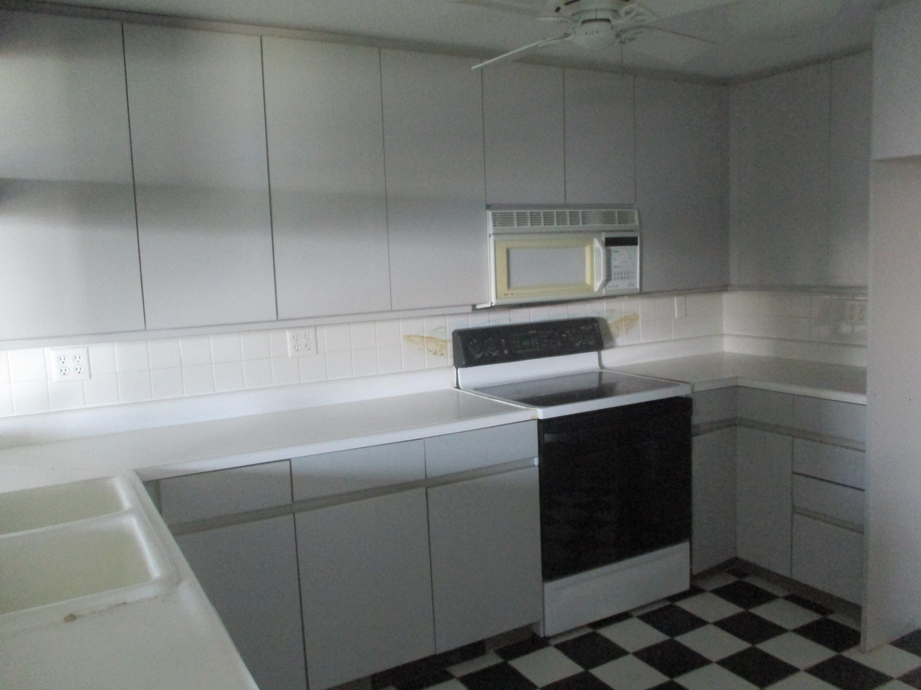112 Old Wharf Road, Unit E4 Dennis Port, MA 02639 - Photo 6 of 15 a kitchen with a sink cabinets and utility
