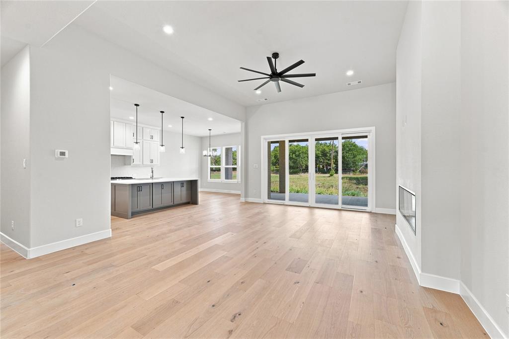 3820 Jack's Loop Midlothian, TX 76065 - Photo 10 of 40 Spacious interior featuring wood-finish flooring, a contemporary ceiling fan, and recessed lighting