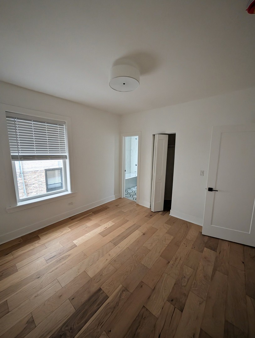 616 West Patterson Avenue, Unit 2E Chicago, IL 60613 - Photo 14 of 18 an empty room with windows and closet