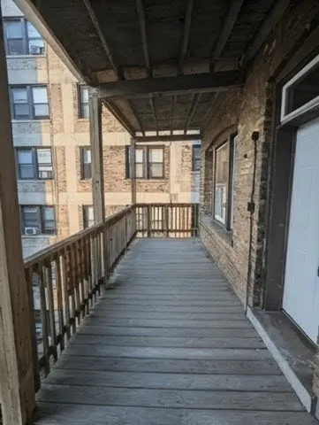 a view of a porch with wooden floor