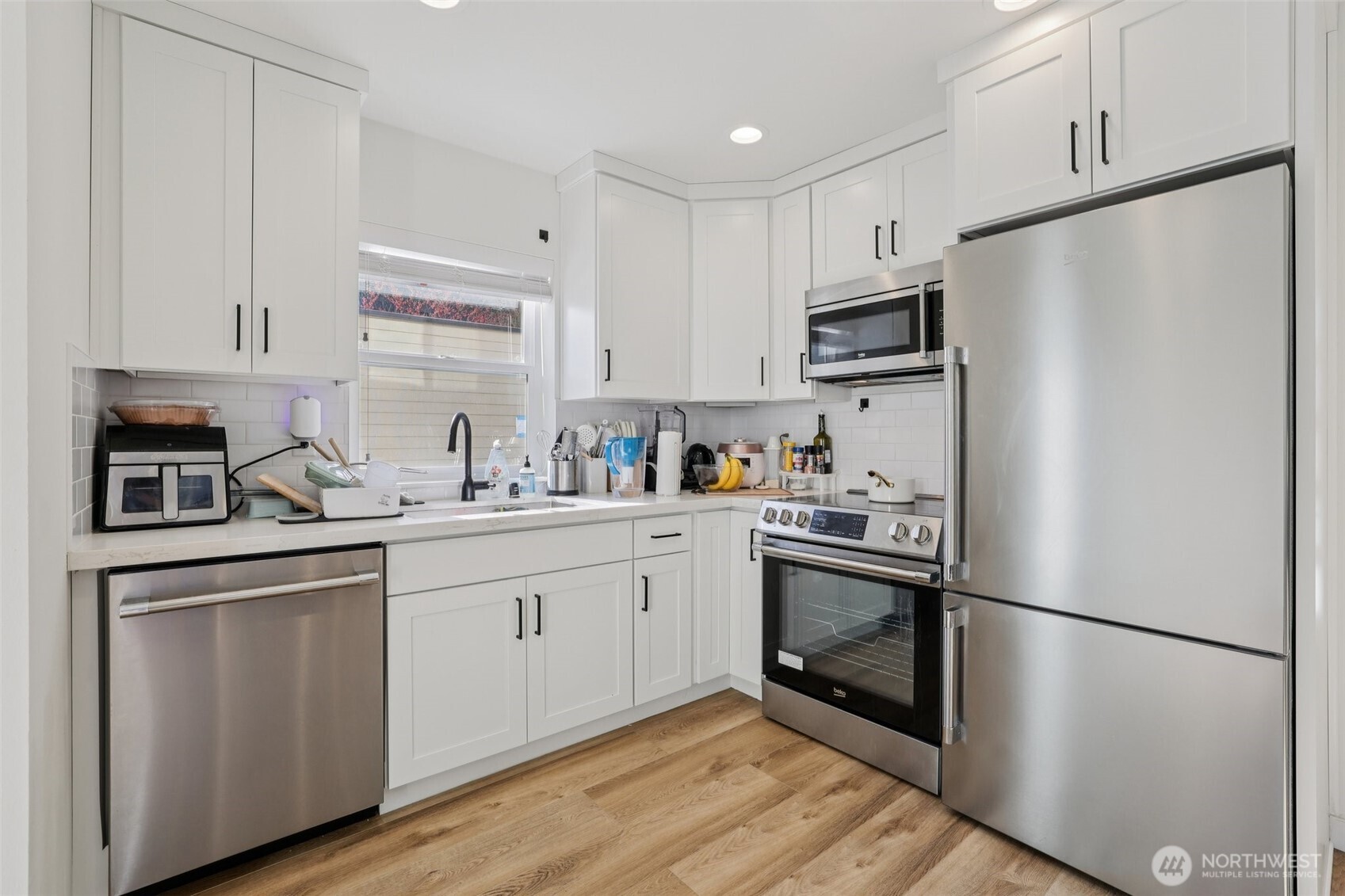 5230 16th Avenue Northeast Seattle, WA 98105 - Photo 26 of 35 a kitchen with stainless steel appliances a refrigerator sink and microwave