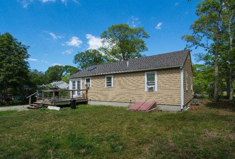 105 Cammett Road Marstons Mills, MA 02648 - Photo 15 of 21 a front view of house with yard and green space