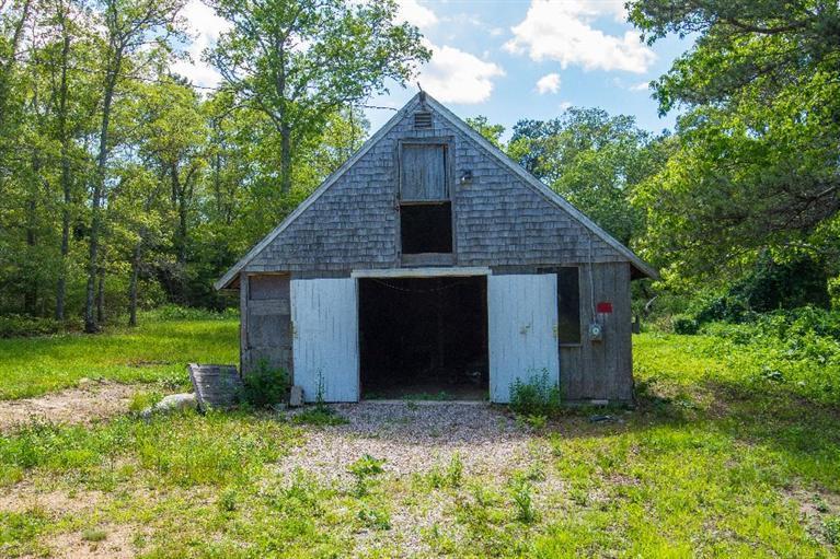 105 Cammett Road Marstons Mills, MA 02648 - Photo 20 of 21 a view of a barn house in the middle of a yard