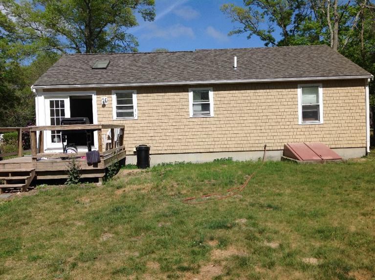 105 Cammett Road Marstons Mills, MA 02648 - Photo 3 of 21 a backyard of a house with seating space