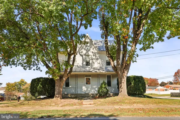 a view of a house with a tree in the background