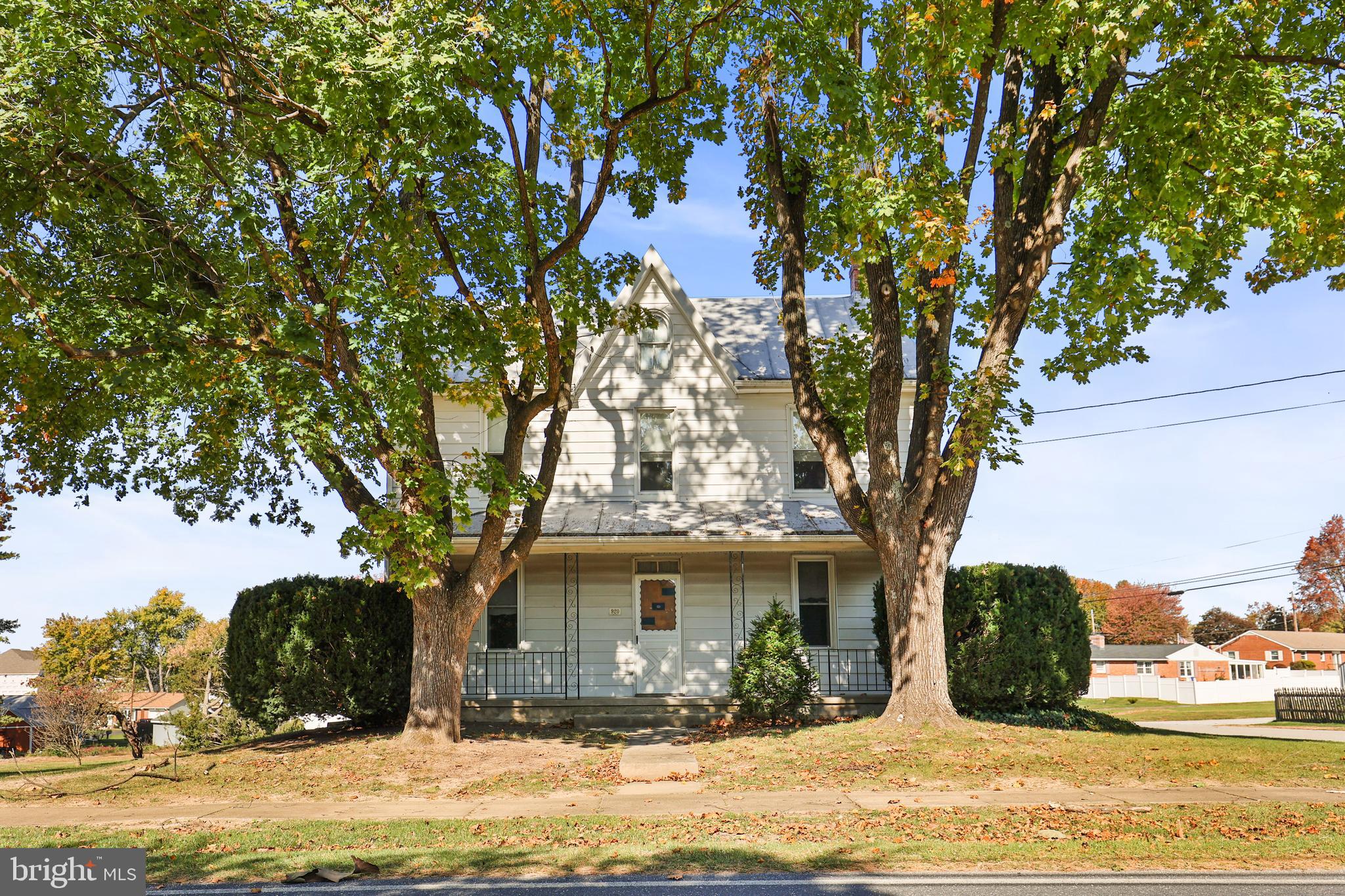 a view of a house with a tree in the background