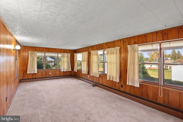 a view of an empty room with large windows