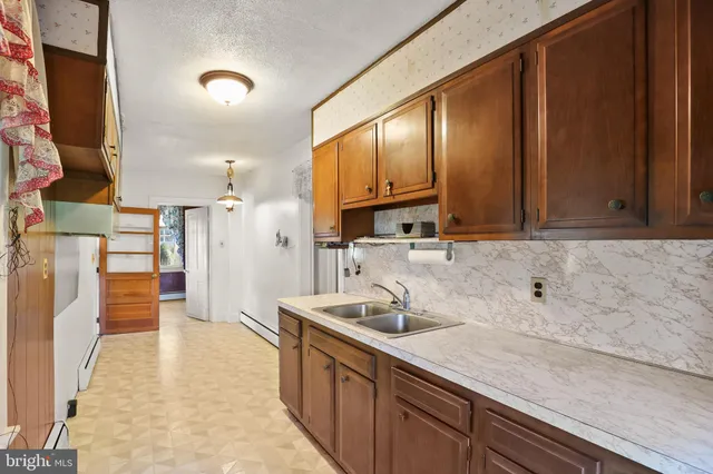 a kitchen with a sink stove and cabinets