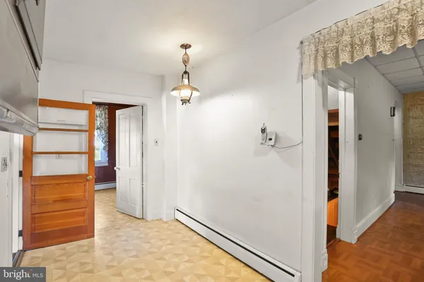 an empty room with wooden floor and window
