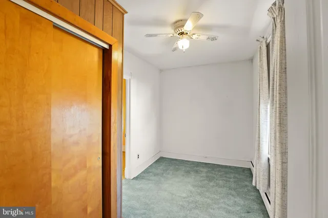 a view of a bathroom with closet and a window
