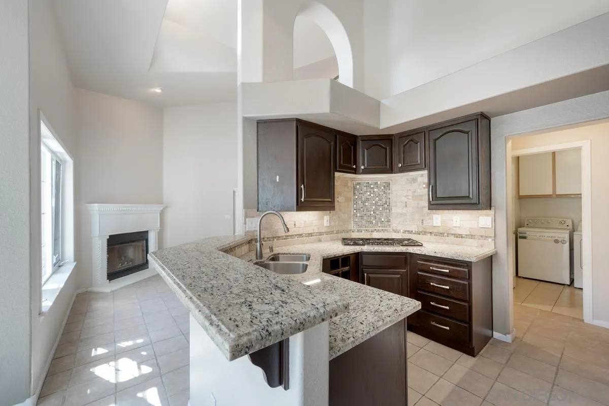 2836 Torrey Pines Road La Jolla, CA 92037 - Photo 13 of 35 a kitchen with a stove sink and cabinets