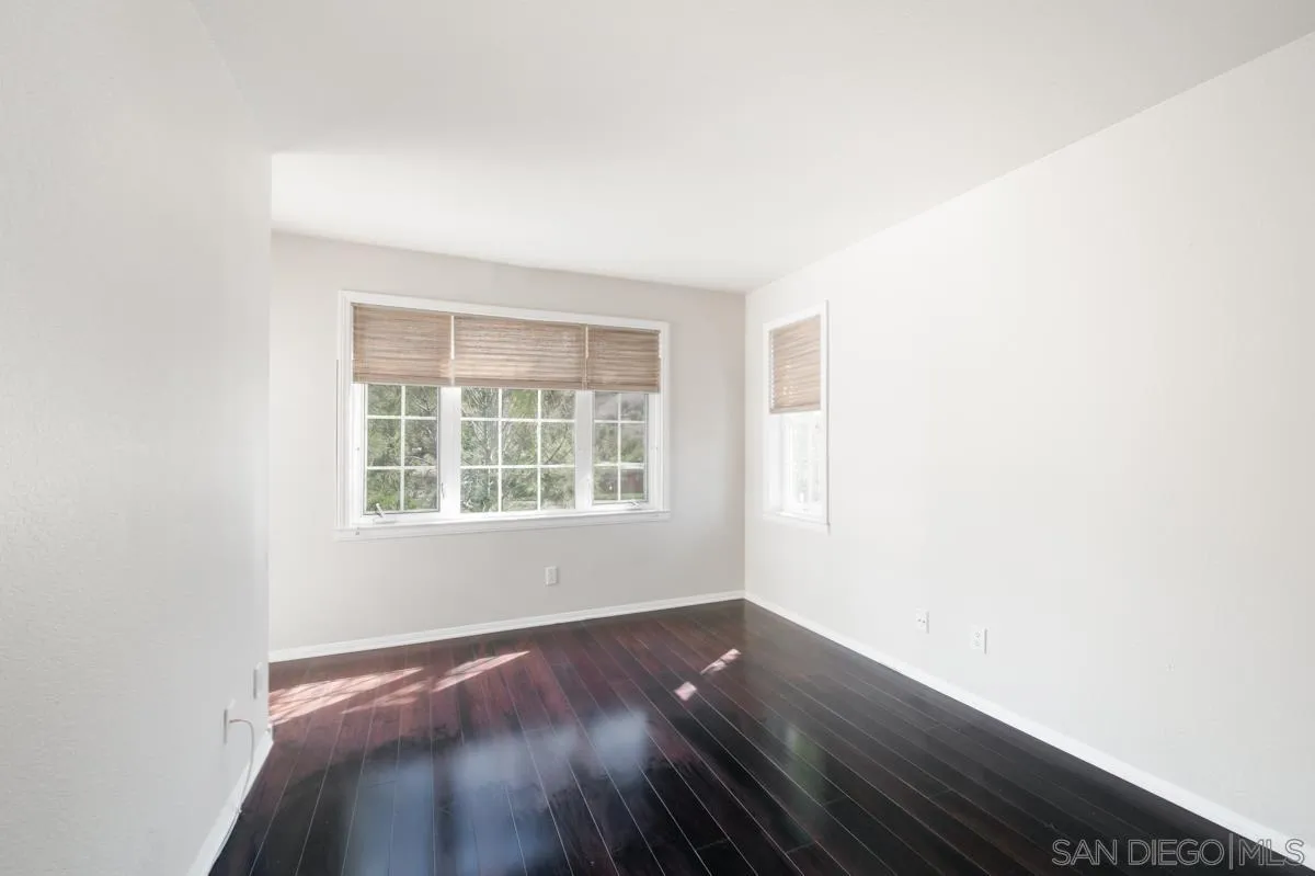 2836 Torrey Pines Road La Jolla, CA 92037 - Photo 27 of 35 an empty room with wooden floor and windows