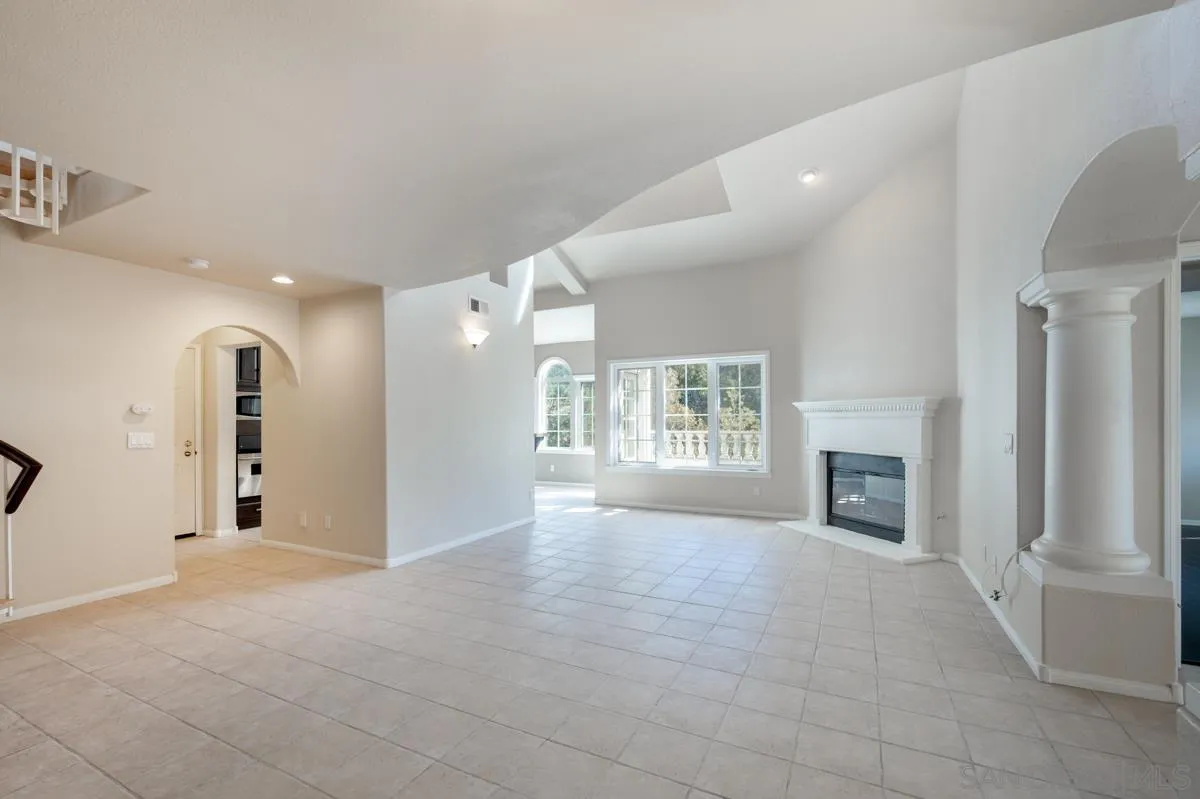2836 Torrey Pines Road La Jolla, CA 92037 - Photo 6 of 35 a view of an empty room with a fireplace and a window