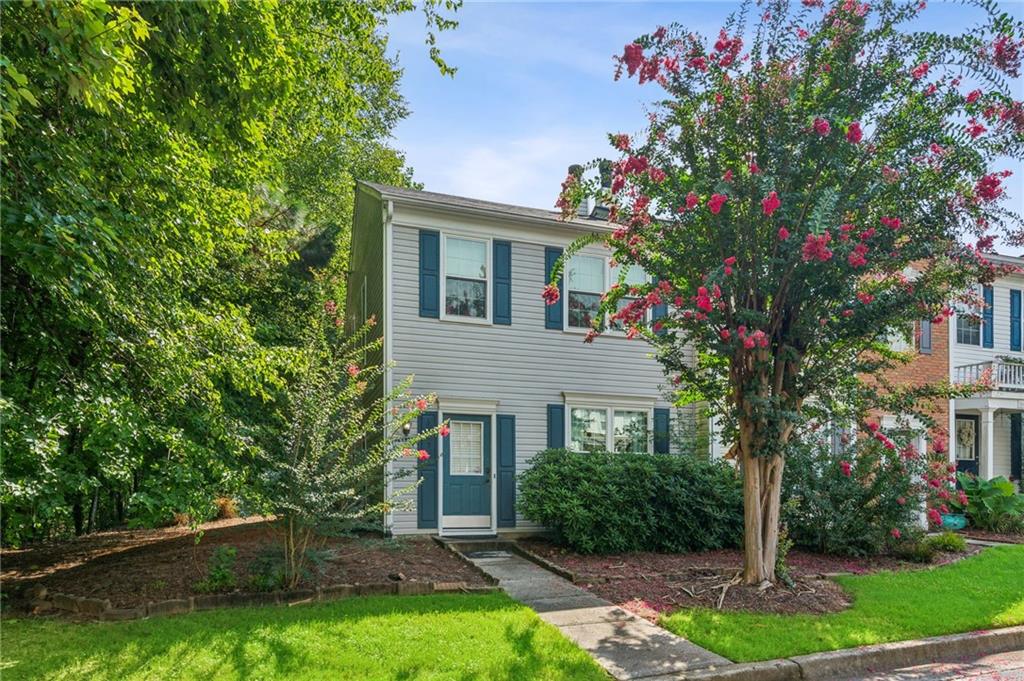 3615 Berkeley Court Duluth, GA 30096 - Photo 1 of 1 a front view of a house with a garden and trees